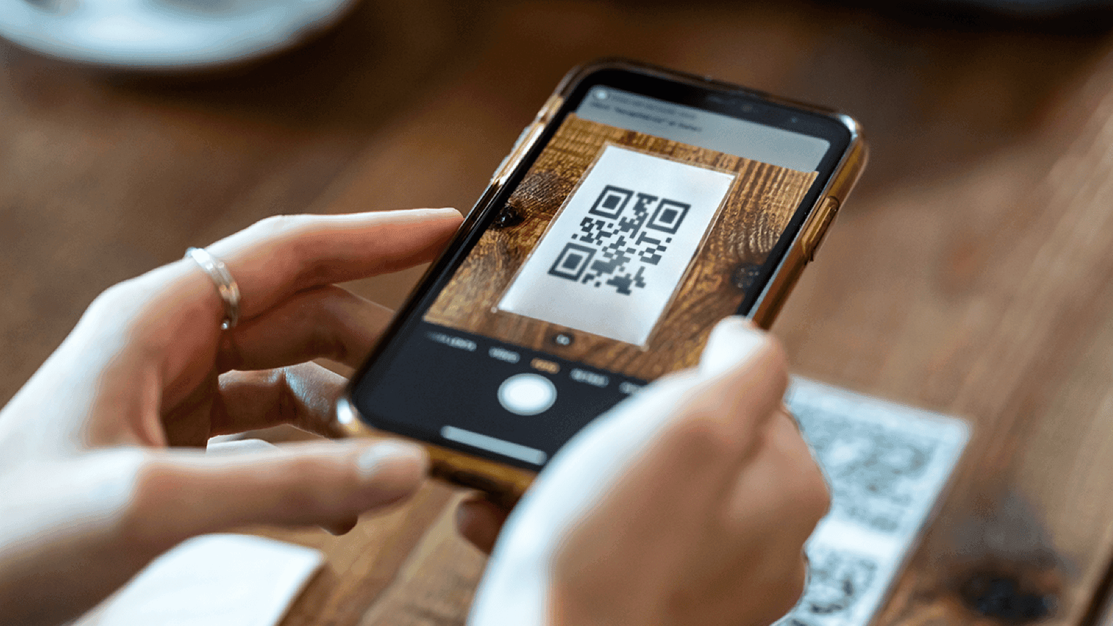 contactless dining customer scanning a QR code with their phoe.png