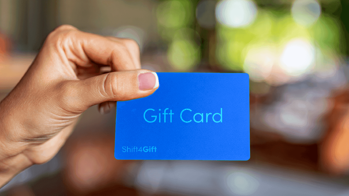 Woman holding a blue gift card that says "Shift4Gift" - SkyTab - Shift4